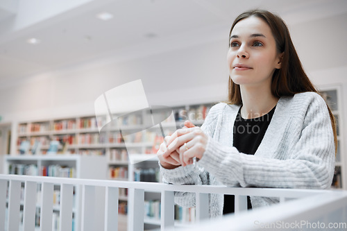 Image of University, thinking and woman in library for knowledge, learning and academic research in building. Education, college and young female student with ideas, vision and happy mindset for future goals