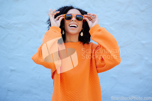 Image of Fashion, sunglasses and black woman isolated on blue background of gen z, youth or cool trendy clothes. Happy person or beauty model for confidence, vision style and orange color streetwear on mockup