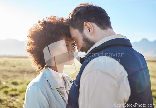 Image of Intimacy, love and couple in nature on a farm for a romantic anniversary or valentines day date. Intimate, affection and interracial man and woman in a romance moment together on a eco friendly field