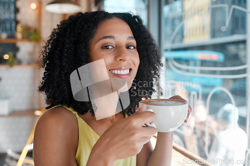 Image of Happy black woman, portrait and relax in coffee shop, restaurant or bistro for lunch, latte and easy lifestyle. Face, cafe and female enjoy cup of drink, cappuccino and break alone with happiness