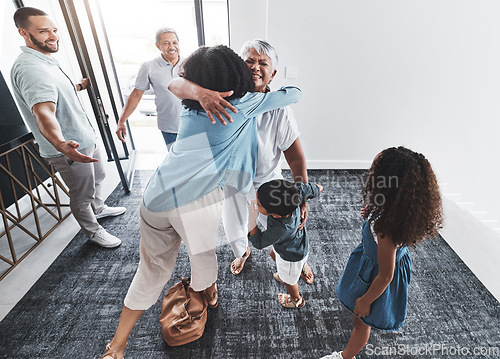 Image of Welcome, family hug and home of a mother, grandparents and children with happiness in a lounge. Living room, happy children and kids with love and parent care in a house with elderly parents