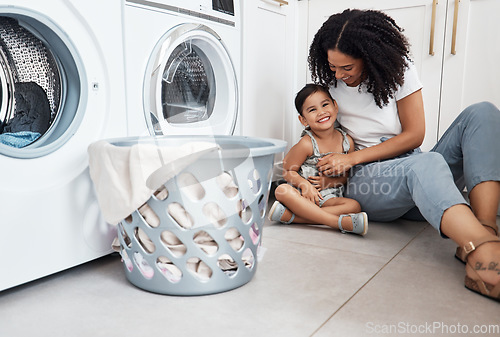 Image of Mom, girl child and basket by washing machine on floor for cleaning, bonding and comic time in house. Laundry, mother and daughter with happiness, love and care in family home with tickle for smile