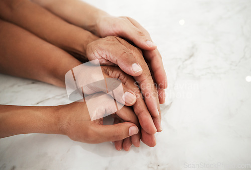 Image of People, hands and touching in care or support for relationship, generations or family on table. Hand of group embracing love, community or trust in unity together, partnership or trust in solidarity