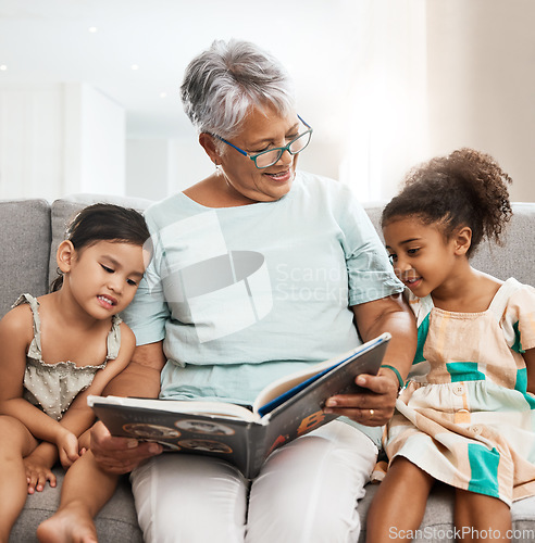 Image of Family, grandmother and children with book reading on sofa for bonding, relaxing and quality time together. Love, education and elderly woman with girls learn to read story, fairy tale and literature