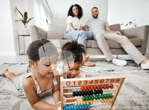 Image of Family home, children and floor with abacus for math learning, development and sibling teamwork. Children, carpet and education toys with mom, dad and sofa with smile, pride and happiness in house