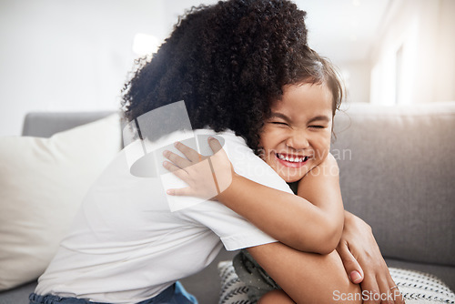 Image of Love, hug and girl with mother on a sofa, happy and smile while hugging in their home together. Family, embrace and parent with child on a couch, bond and cheerful, loving and caring in a living room