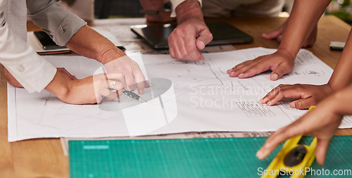 Image of Hands, collaboration and architecture with a designer team planning on a table using a blueprint. Building, planning and teamwork with an engineer employee group at work on project development