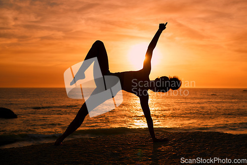 Image of Fitness, yoga and silhouette of woman on beach at sunrise for exercise, training and pilates workout. Motivation, meditation and shadow of girl balance by ocean for sports, wellness and stretching