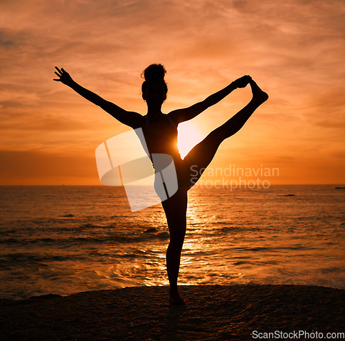 Image of Yoga, stretching and silhouette of woman on beach at sunrise for exercise, training and pilates workout. Motivation, meditation and shadow of girl balance by ocean for sports, wellness and fitness