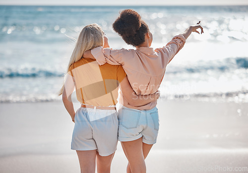 Image of Woman, friends and hug in relax at the beach for summer vacation, travel or journey together in the outdoors. Interracial women hugging and enjoying trip, traveling or adventure by the ocean coast