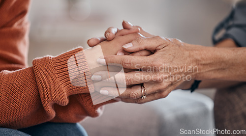 Image of Women, holding hands and closeup for therapy, mental health support or consultation for problem on sofa. Woman, helping hand and psychologist for wellness conversation, advice or care for depression