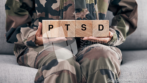 Image of Soldier hands, holding wood block and sofa for therapy, ptsd and help for mental health problem from Ukraine war. Military professional, wooden sign or depression on couch after international combat