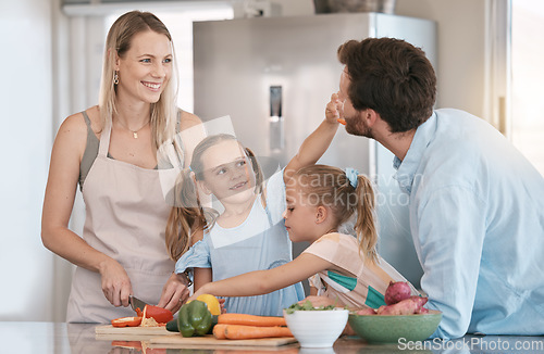 Image of Family, parent and children cooking in kitchen with vegetables for healthy diet, nutrition or meal prep. Bonding, smile and mom, dad and girls learning, teaching and helping cut food ingredients