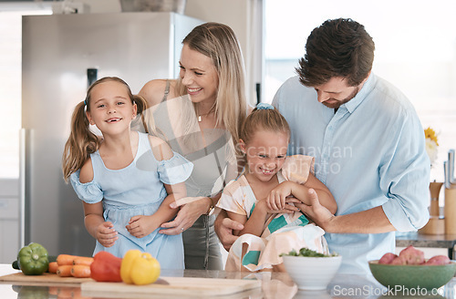 Image of Fun, playful and family cooking food, bonding and children helping in the kitchen for lunch. Happy, laughing and parents playing with girl kids while preparing dinner together for quality time