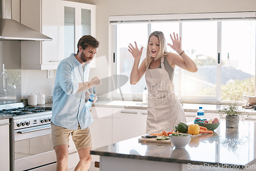 Image of Happy couple, cooking and dancing together in kitchen, home and comic time with happiness, bonding and love. Man, woman and dance in house with vegetables, food and funny moment with hands in air