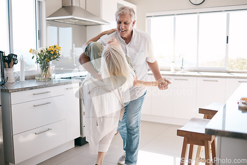 Image of Senior couple dancing, kitchen and happiness with love, care and support in morning at house. Elderly man, old woman and dance together with smile, hands and support in retirement in home with trust