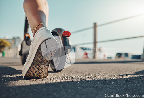 Image of Foot, scooter and travel with eco friendly transportation outdoor, sustainability and sneakers on asphalt in city. Person with sustainable transport in Miami, carbon footprint mockup and adventure