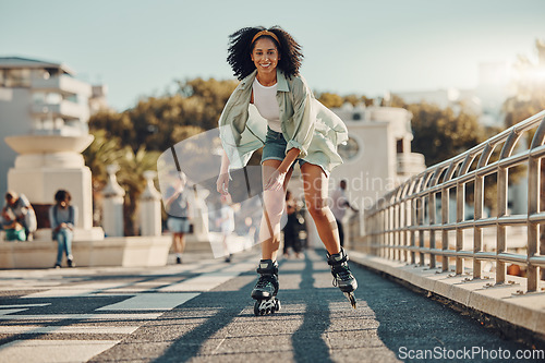 Image of Exercise, city and black woman roller skating for fitness, health and wellness outdoors. Sports practice, training and portrait of happy female skater in street, having fun and enjoying exercising.