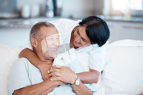 Image of Love, retirement and smile with a senior couple in the living room of their home together to relax. Sofa, bonding or marriage with a mature man and woman relaxing in the lounge of their house