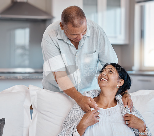 Image of Love, retirement and happy with a senior couple in the living room of their home together to relax. Sofa, bonding or marriage with a mature man and woman relaxing in the lounge of their house