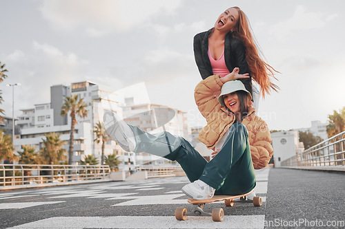 Image of Fun, comic and portrait of friends on a skateboard for the weekend, bonding and playing in the city. Energy, smile and crazy women skateboarding for funny activity, happiness and playful in Sweden