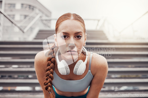 Image of Fitness, sports and portrait of woman in city with motivation, determination and focus for health goals. Running, exercise and face of girl in urban town for workout, wellness and marathon training