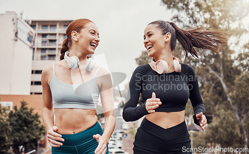 Image of Fitness, city and friends running together for a wellness, health and endurance exercise. Sports, healthy athletes and happy women runners doing a cardio workout for sport training in a town.