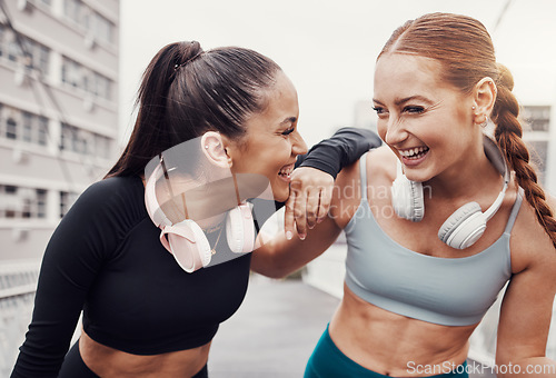 Image of Fitness, music and laugh with runner friends in the city for a cardio or endurance workout together. Exercise, running or happy with a female athlete and friend laughing outdoor in an urban town
