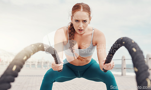 Image of Woman, battle rope exercise and portrait at ocean park for fitness, strong body and wellness at outdoor training. Girl, focus and workout by sea with goal, target or motivation for muscle development