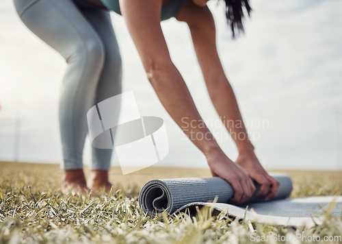 Image of Roll, yoga or woman in nature to start body training, exercise or workout on grass for zen mindfulness. Hands, fitness or healthy person rolling a mat for a peaceful or calm meditation in summer