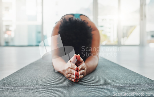 Image of Yoga, arm stretching and prayer hands of a black woman in a gym for zen, relax and exercise. Pilates, peace and meditation training of an athlete in prayer pose on the floor feeling calm from stretch