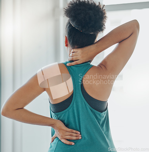 Image of Black woman, neck and back pain at exercise, training or workout for physical development in home. Girl, muscle stress and burnout at gym for fitness, wellness and performance with injury in gym