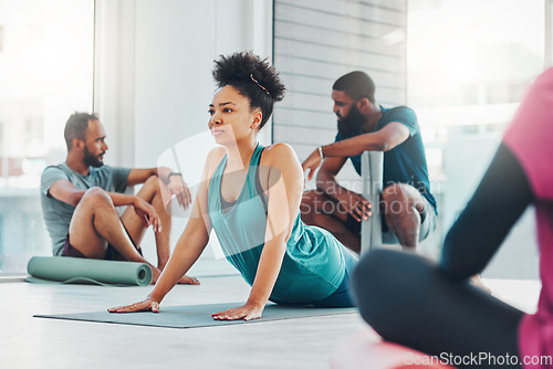 Image of Yoga, fitness class and people exercise together for health, peace and wellness. Black woman and men group in health studio for holistic workout, cobra and body balance with zen energy or mindfulness