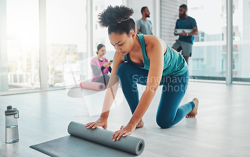 Image of Yoga, studio and exercise mat with a fitness black woman getting ready for a wellness workout. Gym, training and zen with a female yogi indoor for mental health, balance or spiritual health