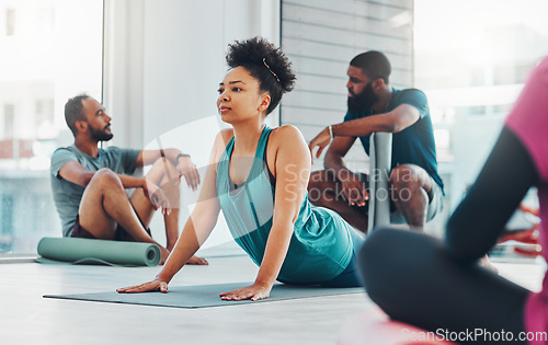 Image of Yoga class, people and fitness exercise for health, peace and wellness at a gym. Black woman and men group in health studio for holistic workout, cobra and body balance with zen energy or mindfulness