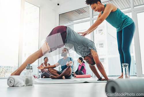 Image of Yoga instructor, exercise and man in class for fitness, health and wellness workout. Healthy people in a pilates studio with a happy coach teaching stretching for body balance training with help