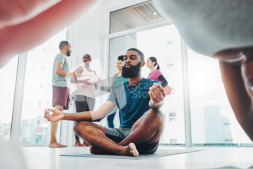 Image of Yoga, meditation and black man do lotus exercise for fitness, peace and wellness in class. Young sports person in health studio for holistic workout, mental health and body balance with zen energy