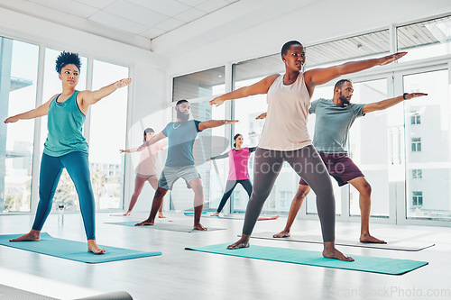 Image of Yoga class, exercise and fitness people in warrior or stretching for health and wellness. Diversity men and women group together in pilates studio for holistic workout or body balance with zen energy