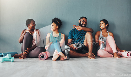 Image of Yoga, fitness group and diversity of pilates class in a gym with a exercise and training break. Talking, wellness people and communication of friends on a floor ready for zen, balance and relax