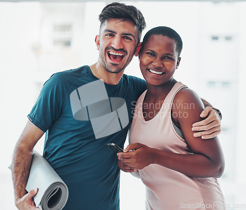 Image of Portrait, yoga and a couple of friends in a studio for fitness while holding an exercise mat and phone together. Happy, excited and joy with diversity yogi people indoor for a wellness workout