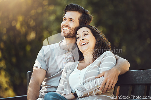 Image of Love, couple and relax on park bench, laughing and having fun together outdoors. Valentines day, romance hug and care of man and woman sitting on romantic date, laugh at funny joke or comic comedy.