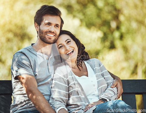 Image of Couple, love and hug on park bench, laughing at funny joke or comic comedy and having fun together outdoors. Valentines day, romance relax and portrait of man and woman hugging on romantic date.