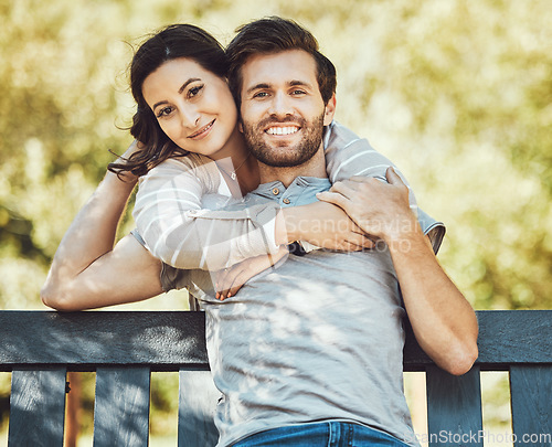 Image of Love, couple and hug on park bench, portrait and having fun time together outdoors. Valentines day, romance relax and care of man and woman hugging, embrace and cuddle on romantic date and smile.