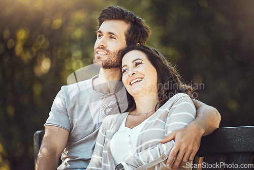 Image of Love, couple and hug on park bench, laughing at funny joke or comic comedy and having fun together outdoors. Valentines day, romance relax and man and woman thinking and embrace on romantic date.