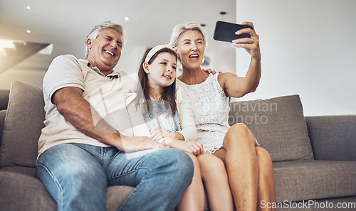 Image of Selfie, love or happy grandparents with girl in living room bonding as a family in Australia taking pictures. Smile, senior or elderly man relaxing with old woman or child at home together on holiday