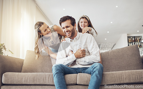 Image of Laughing, family or bonding in tickle game on home sofa, living room or house for funny, comic or comedy activity. Smile, happy or child ticking father with mother, mom or woman in silly or goofy fun