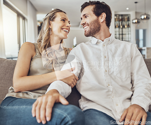 Image of Funny, care and couple on the sofa to relax with love, smile and gratitude in living room. Happiness, laughing and happy man and woman comfortable on the couch for peace, conversation and affection