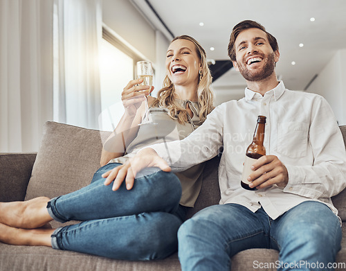 Image of Couple relax with alcohol drink, watching tv and funny with quality time together in living room with love and commitment. Happy people, comedy entertainment and laughter with happiness at home