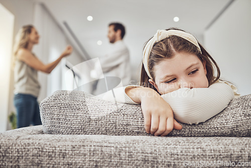 Image of Sad little girl, sofa and parents in conflict, disagreement or fight in the living room at home. Family, divorce and husband in argument with wife and unhappy child on lounge couch in depression