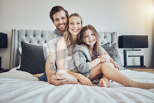 Image of Love, relax and portrait of a family on a bed embracing, bonding and resting together at their home. Happiness, mother and father sitting and relaxing with their girl child in their bedroom in house.